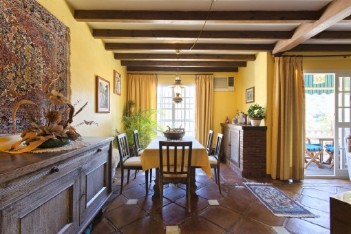 Dining area with wooden ceiling beams