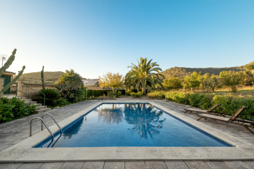 Idyllic pool area with sunbeds