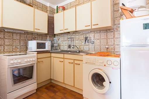 Small kitchen with laundry