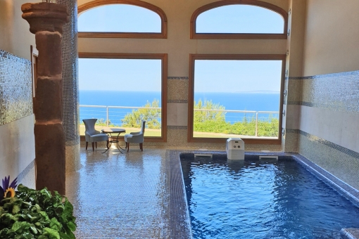 Indoor pool with panoramic sea views