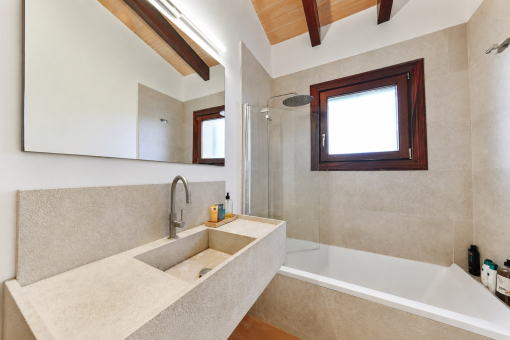 Modern bathroom with bathtub and window