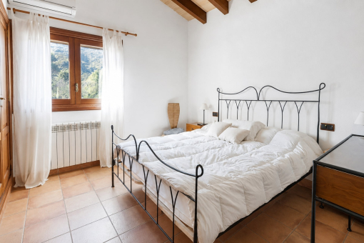 Bright bedroom with iron bed frame