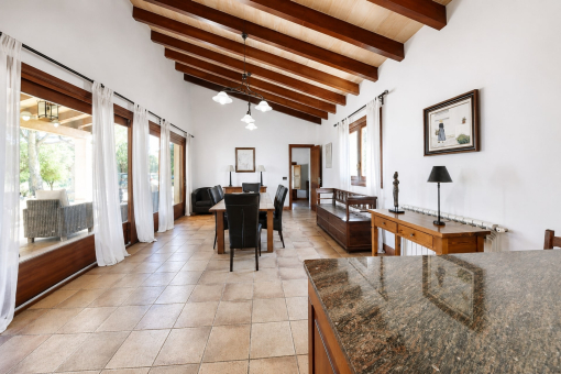 Spacious living and dining area with beamed ceiling