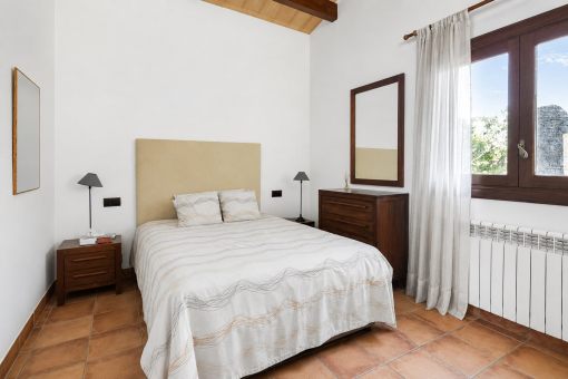 Simple bedroom with wooden furniture and window