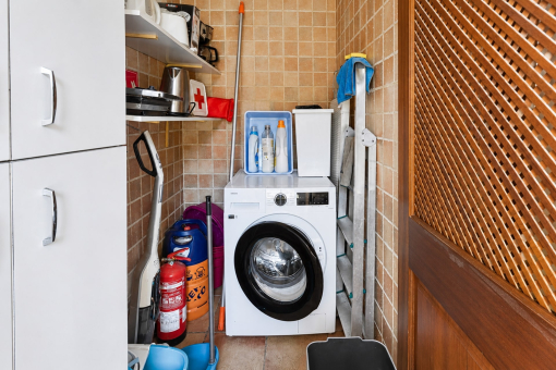 Compact laundry room with washing machine