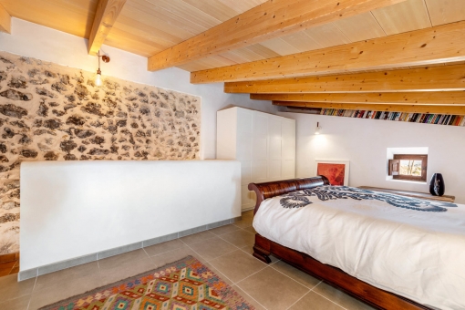 Bedroom with natural stone wall