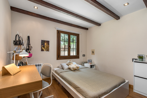 Cozy bedroom with wooden beams
