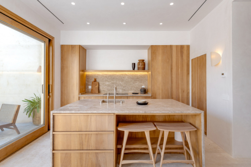 Bright designer kitchen with natural materials and patio access