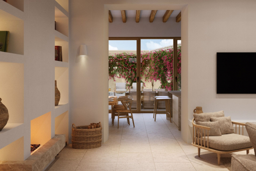Cosy living room with fireplace and view of the Mediterranean courtyard