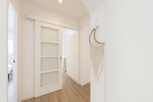 Bright upper floor hallway with sliding door