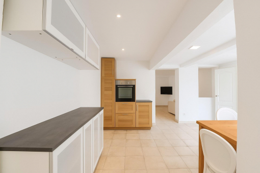 Second kitchen angle with built-in oven and ample storage