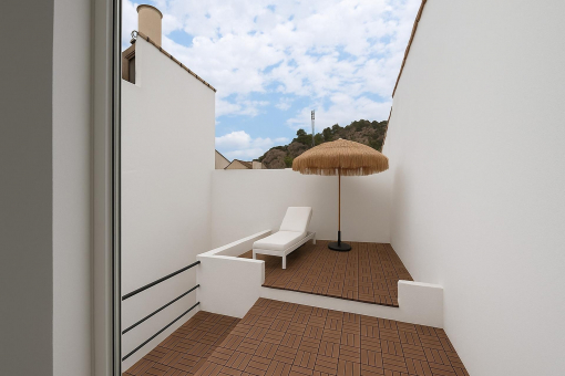 Private sun deck with mountain views and tropical umbrella