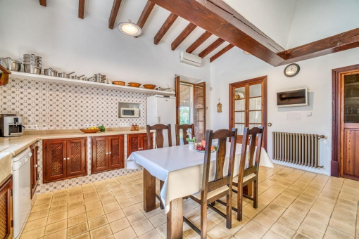 Spacious kitchen in Mallorcan style – with plenty of storage space dining area and access