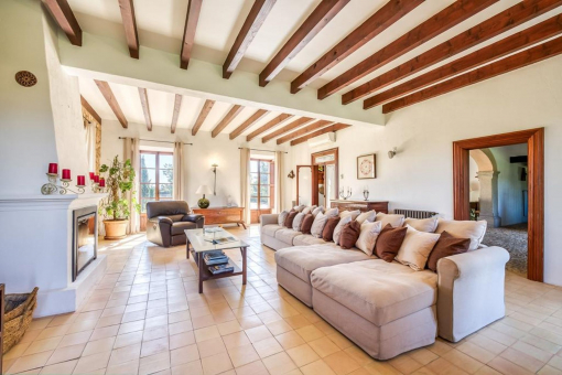 Inviting living room with comfortable sofa area wooden beams and Mediterranean flair