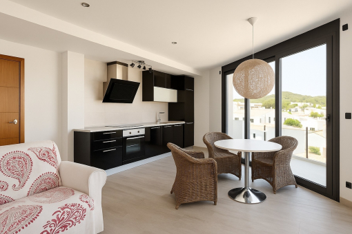 Kitchen with dining area and balcony