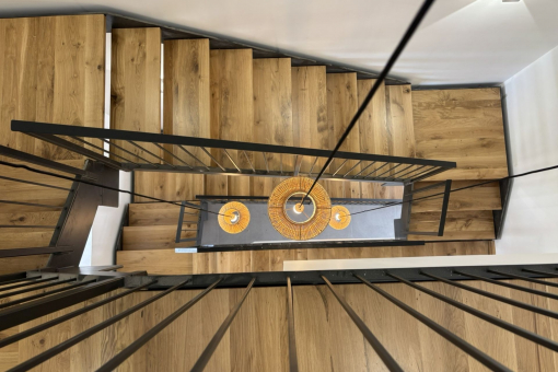 View into the open stairwell with wood and steel