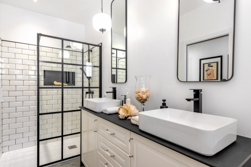 Elegant bathroom with double sink and glass shower