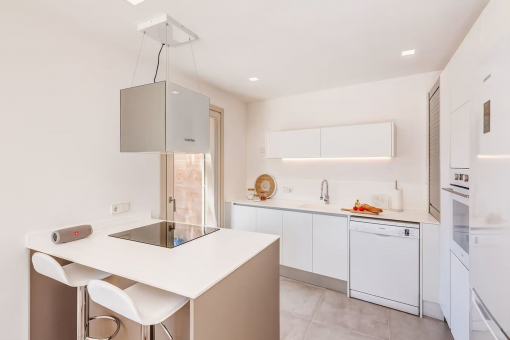 Open kitchen with cooking island and breakfast area