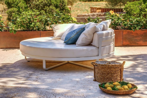 Outdoor lounge area with pool and garden view