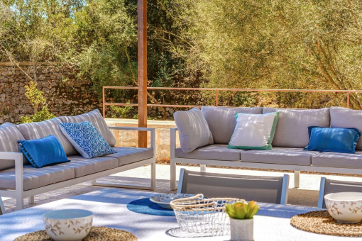 Outdoor lounge area with pool and garden view