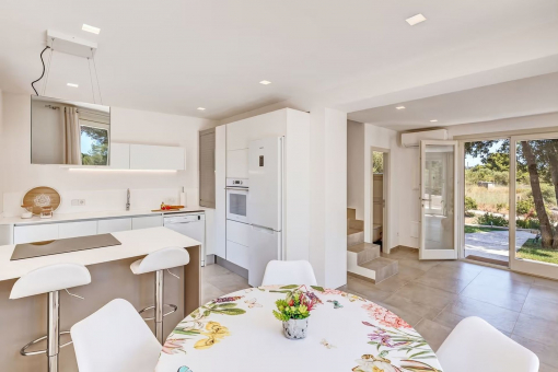 Open kitchen with cooking island and breakfast area