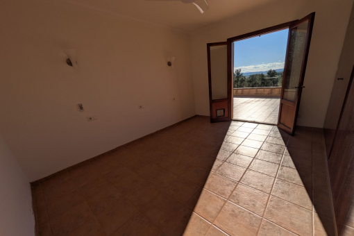 Bright bedroom with access to the terrace and views of the countryside