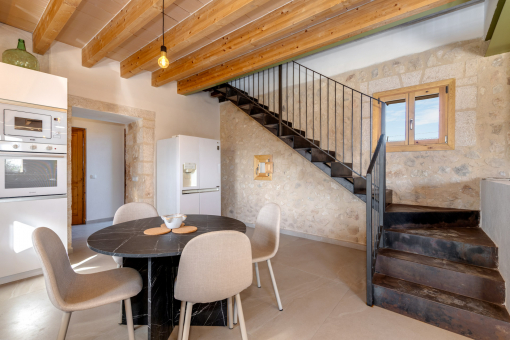 Dining area with natural stone wall and open-plan layout