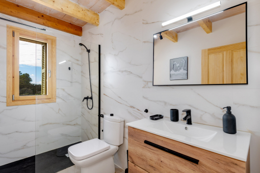 Modern bathroom with stylish natural stone and walk-in shower