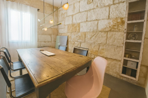 Rustic dining room with stone wall