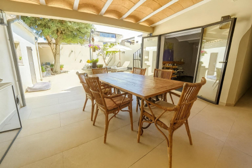 Covered outdoor dining area with garden