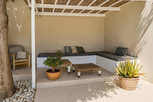 Shaded outdoor lounge area with plants
