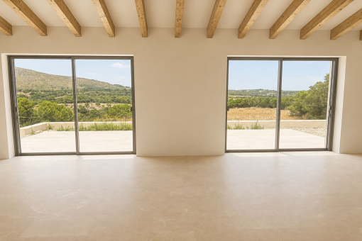 Living and dining area overlooking the countryside and pool
