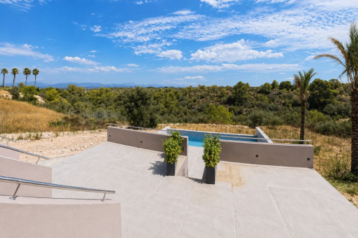Sunny pool terrace with open landscape views