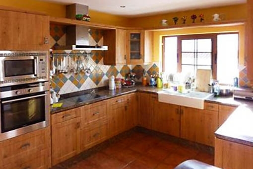 Rustic kitchen with wood panelling and granite worktops
