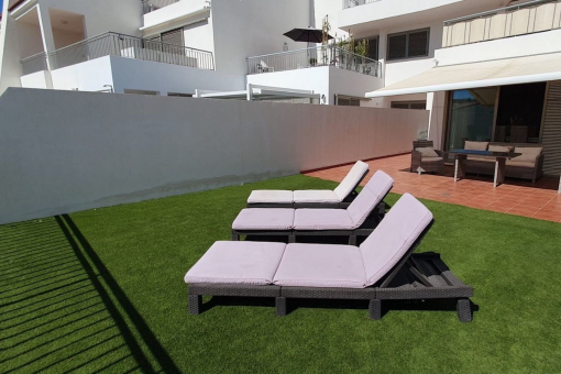 Terrace with sun loungers and outdoor dining area