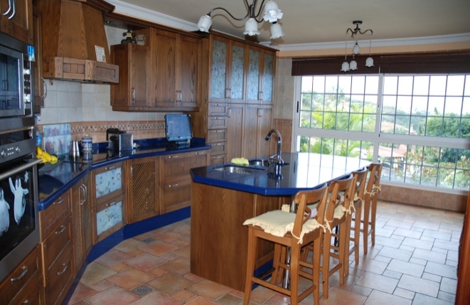 Large kitchen in a beautiful wood design with additional pantry