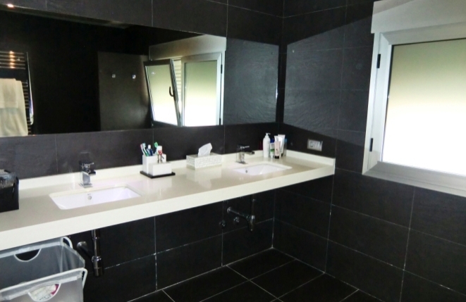 Luxurious bathroom with double sinks and rain shower