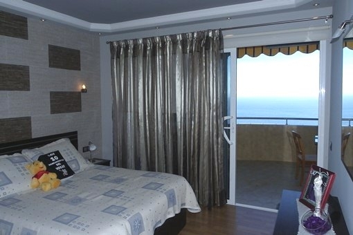 The master bedroom with ocean view and balcony access