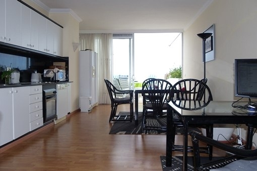 The open kitchen with dining area and access to the terrace