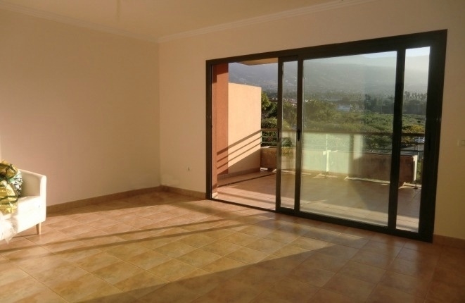 Spacious living room with glass façade and access to the balcony