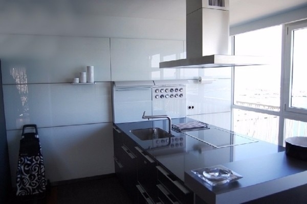 The bright, modern kitchen with large windows