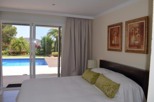 One of the bedrooms with access to the pool